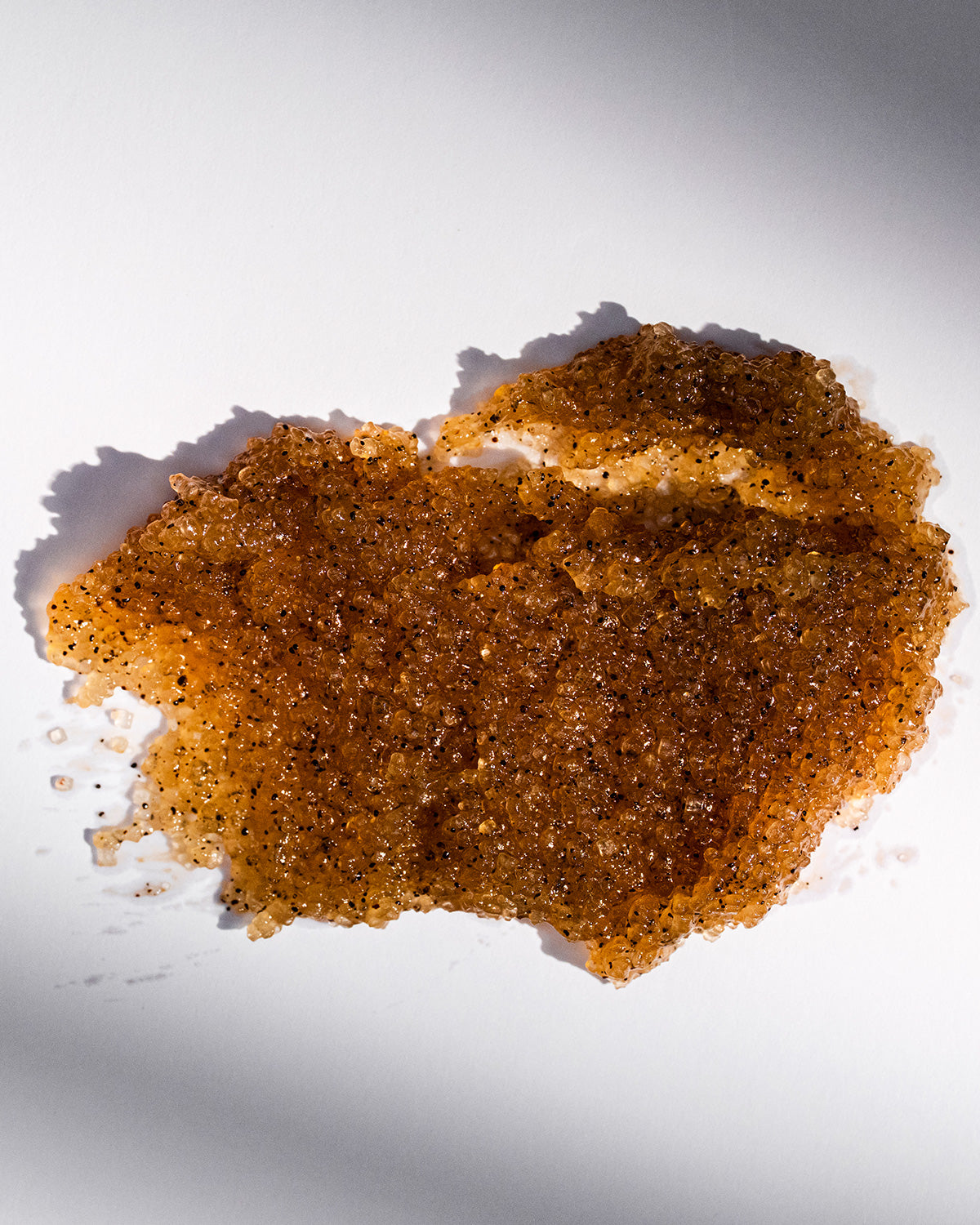 body exfoliant scrub spread on a white surface