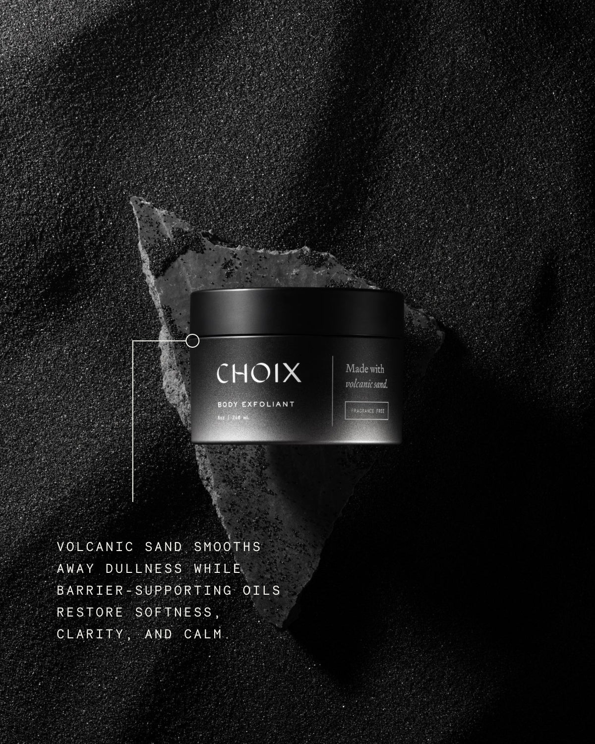 CHOIX fragrance free body exfoliant jar on a dark volcanic sand background with text about product benefits like barrier support and restoring skin softness