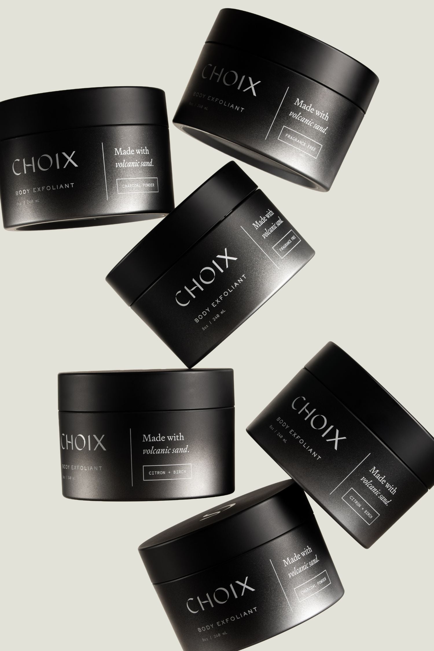 Black jars of CHOIX body exfoliant on a light gray background