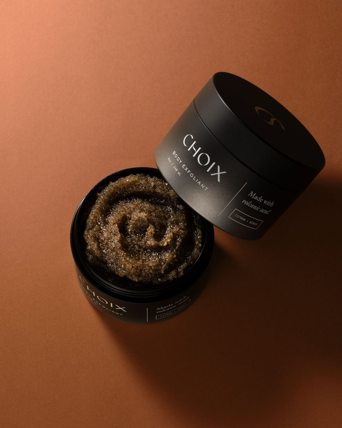 CHOIX Citron and Birch body scrub container with open lid on a brown background