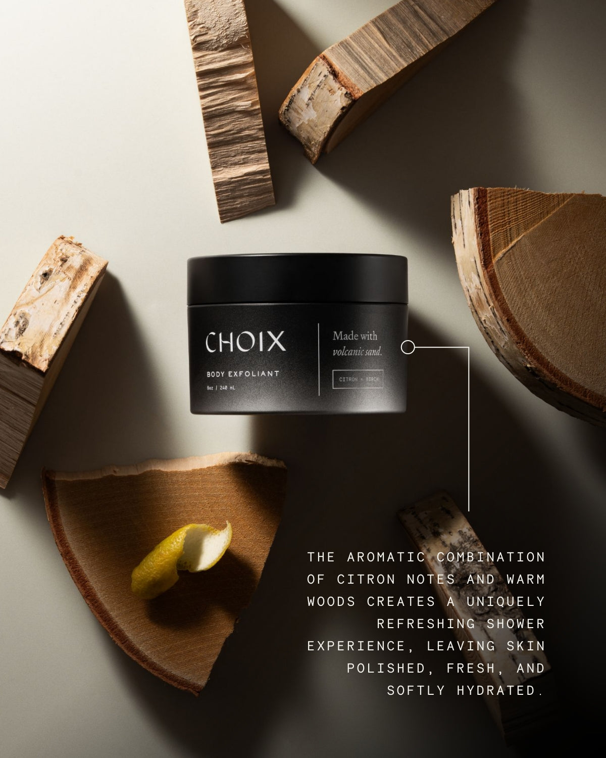 CHOIX Citron and Birch body exfoliant jar with wooden elements on a neutral background with text about benefits like leaving skin polished and hydrated