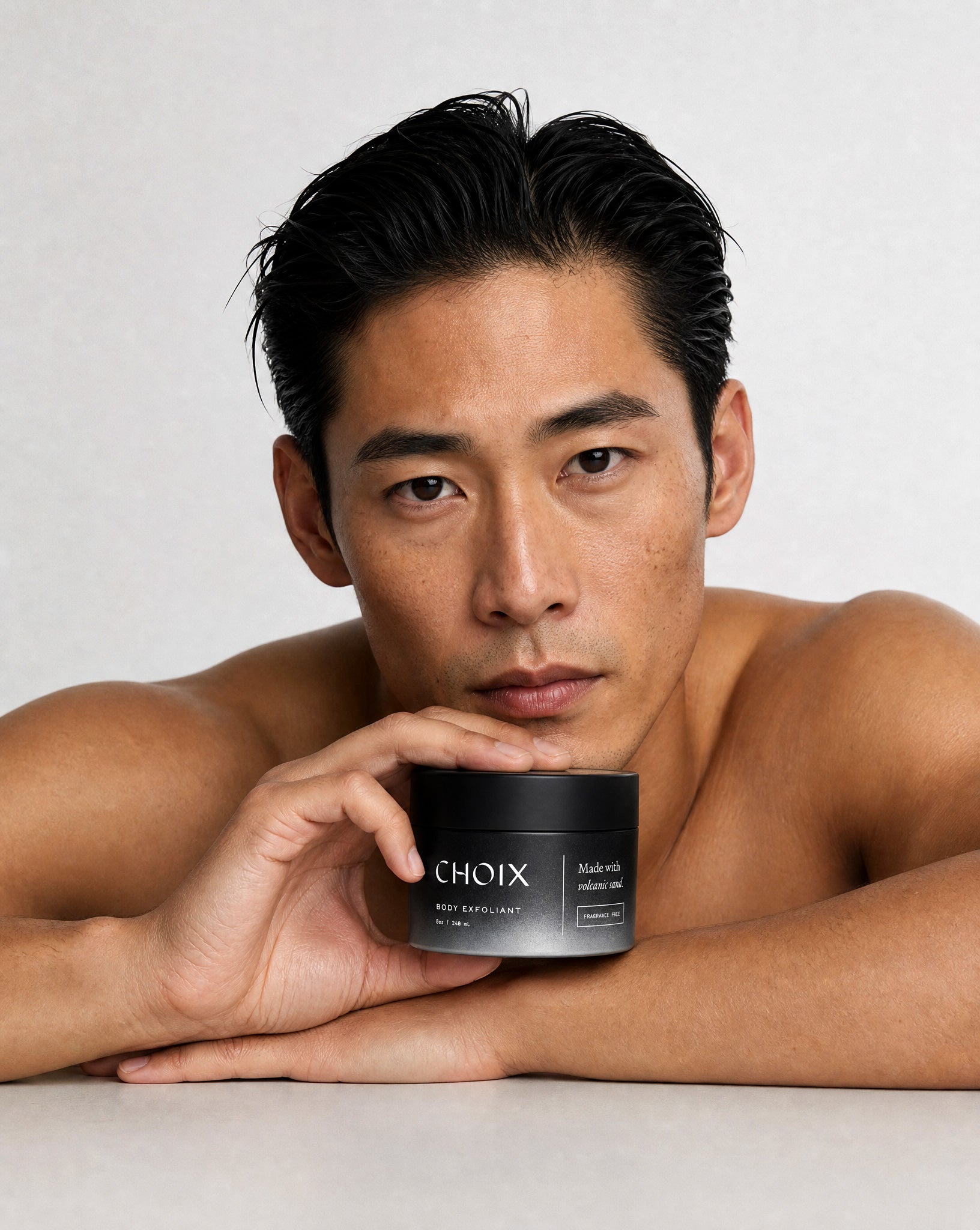 man holding CHOIX body exfoliant jar